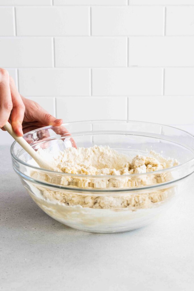 Mixing the muffin batter with a wooden spoon
