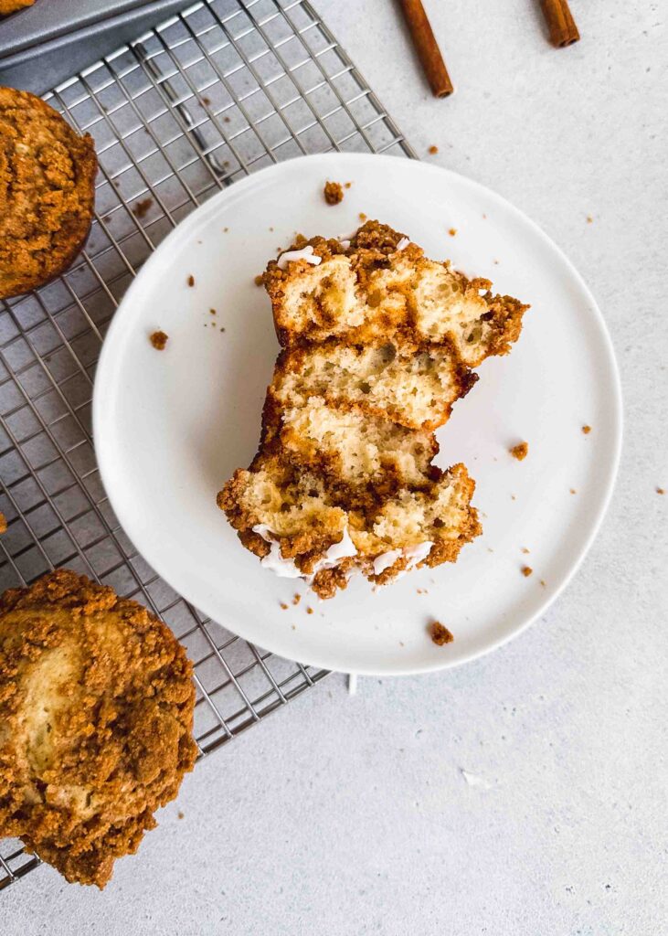 Coffee Cake muffins broken in half served on a white plate