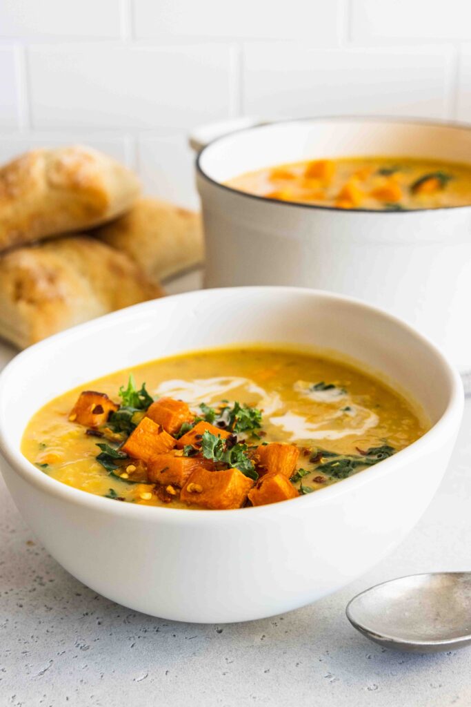 Sweet potato red lentil soup with a drizzle of coconut milk