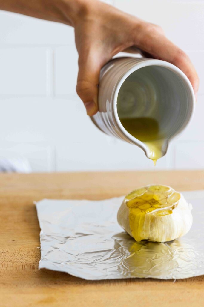 Pouring olive oil over the garlic