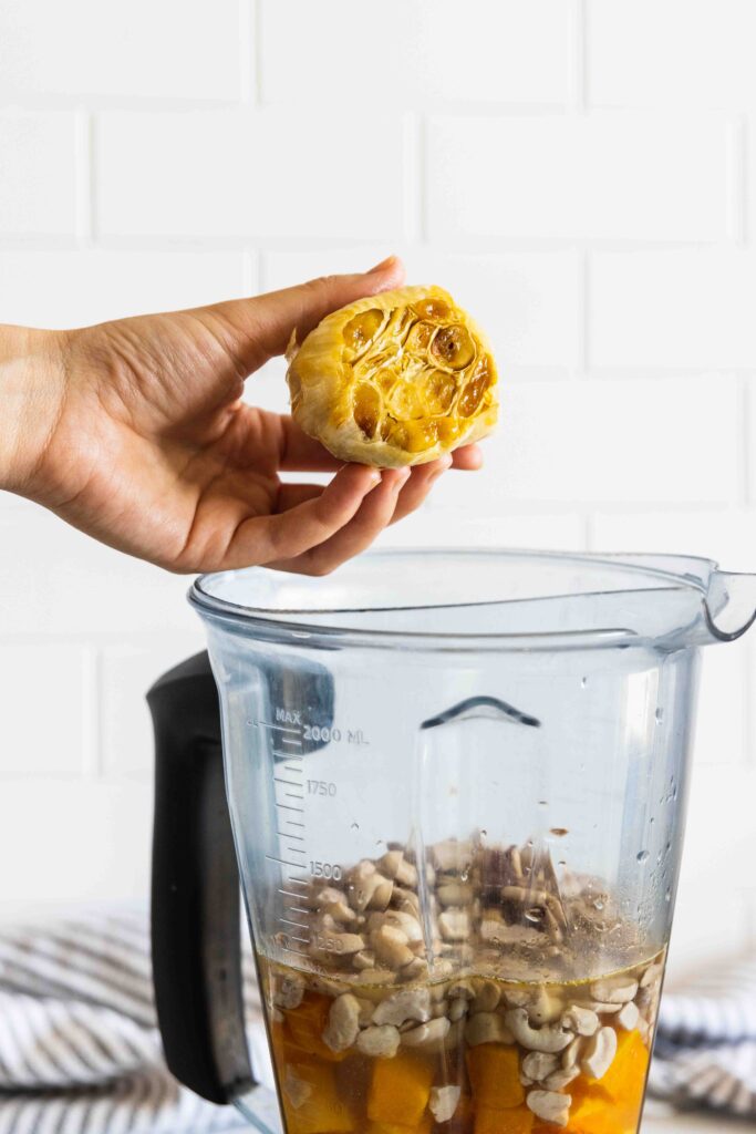 Squeezing the roasted garlic out of the bulb