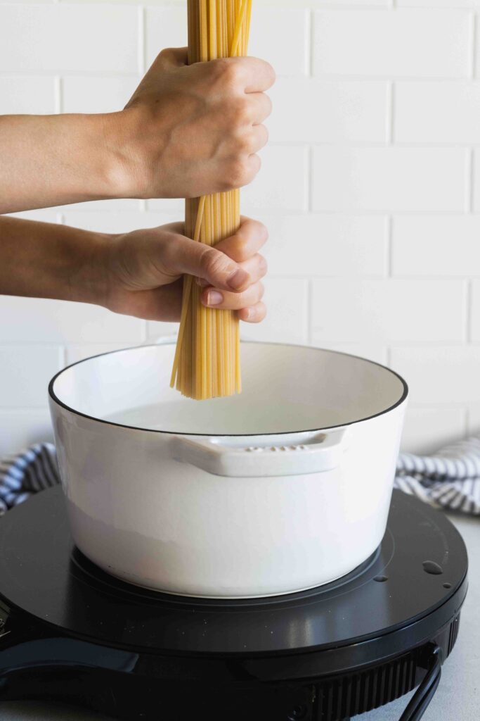 Adding the pasta to the boiling water