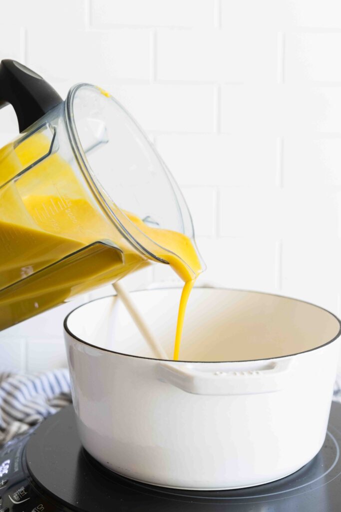 Pouring in the blended butternut squash mixture