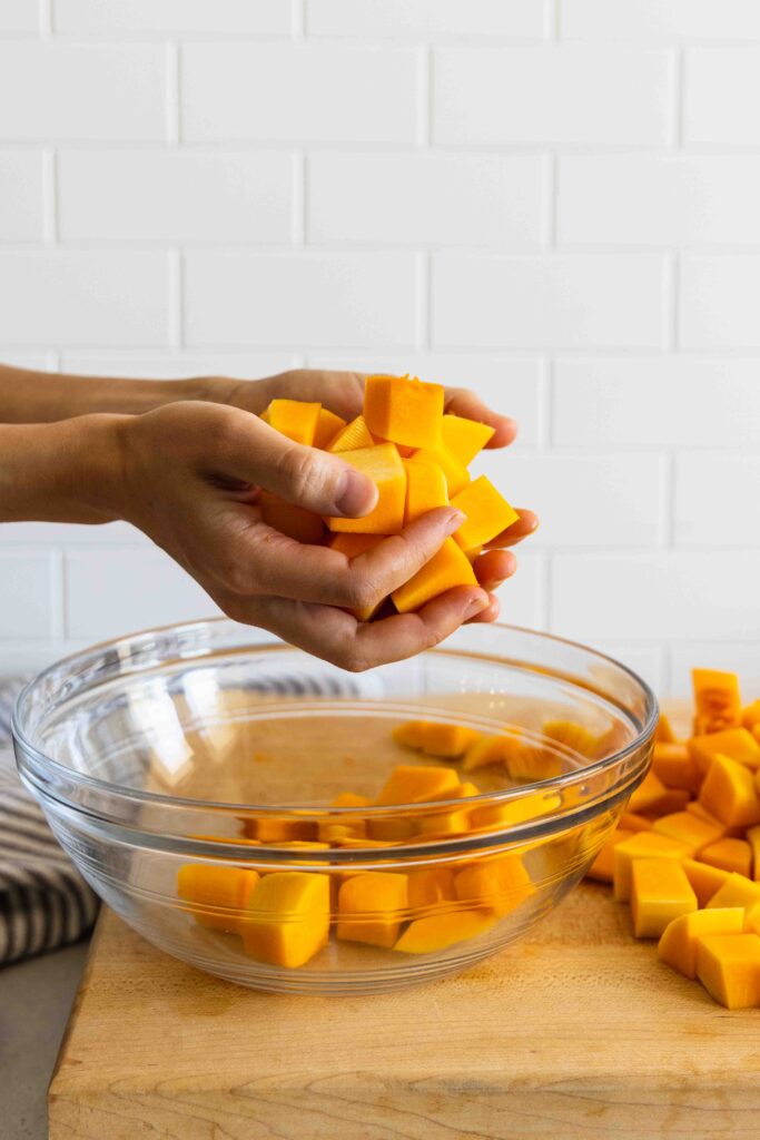 Putting the diced butternut squash in a bowl