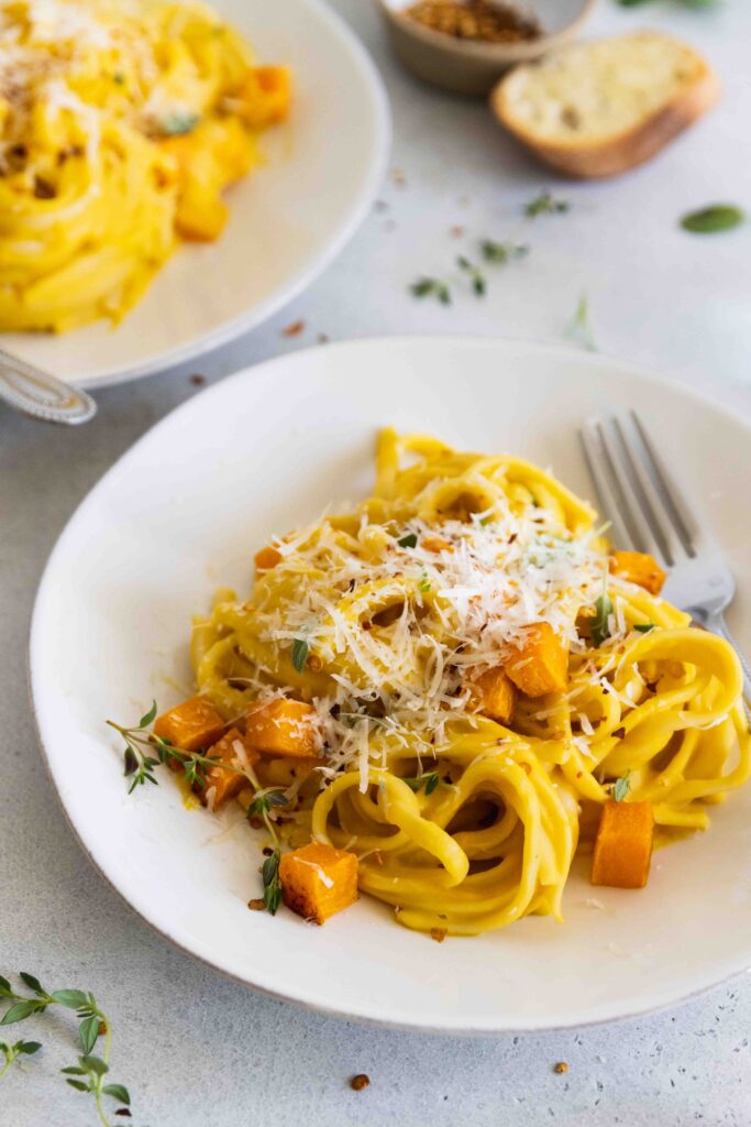Butternut squash pasta served on two white plates