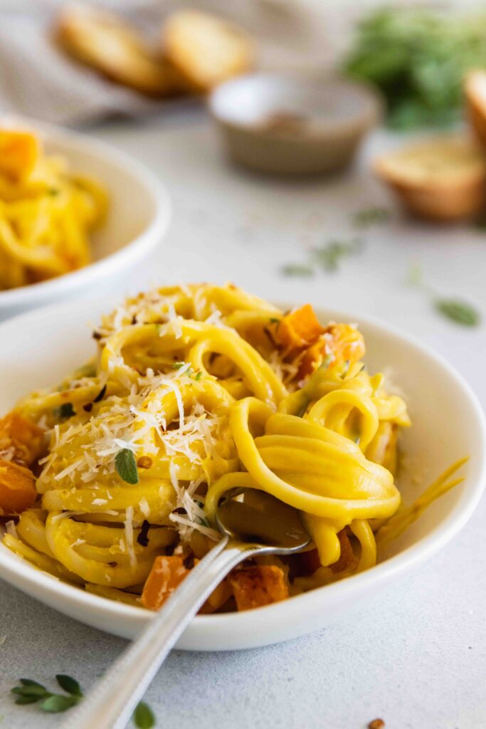 Fettuccine pasta tossed in a roasted butternut squash sauce and served in a bowl