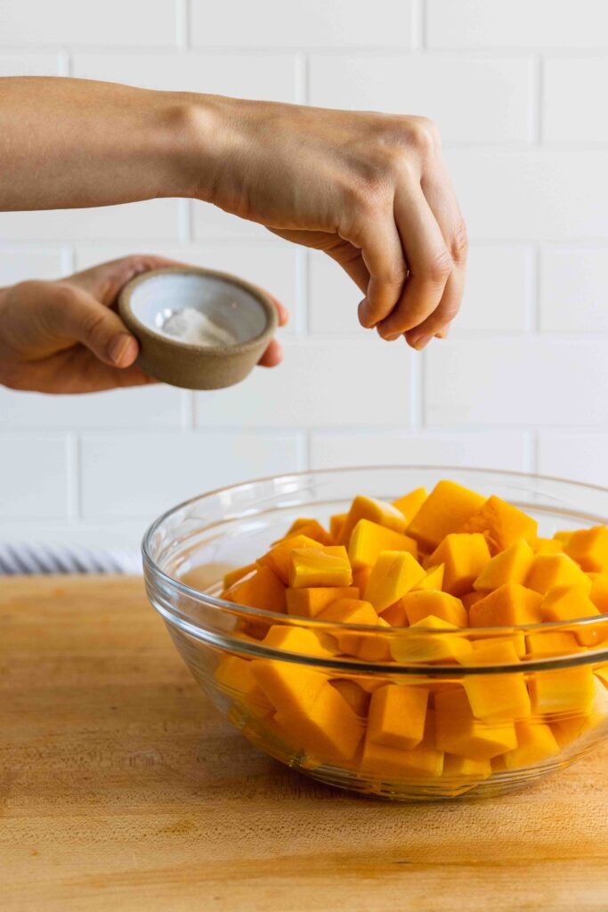 Sprinkling the butternut squash with sea salt