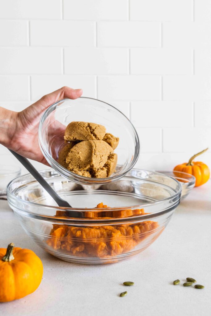 Adding brown sugar to the mixing bowl