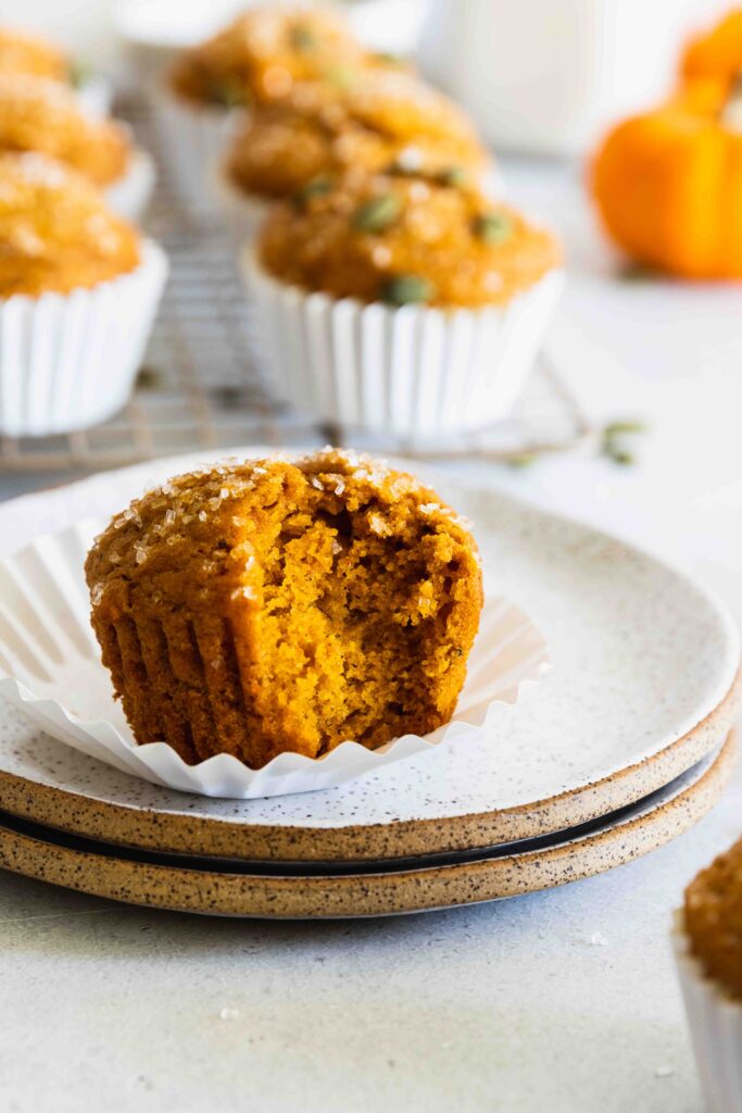 Vegan pumpkin muffins with a bite taken out of it