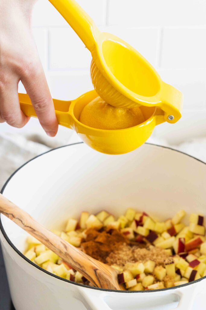 Adding lemon juice to the apple filling in a pot