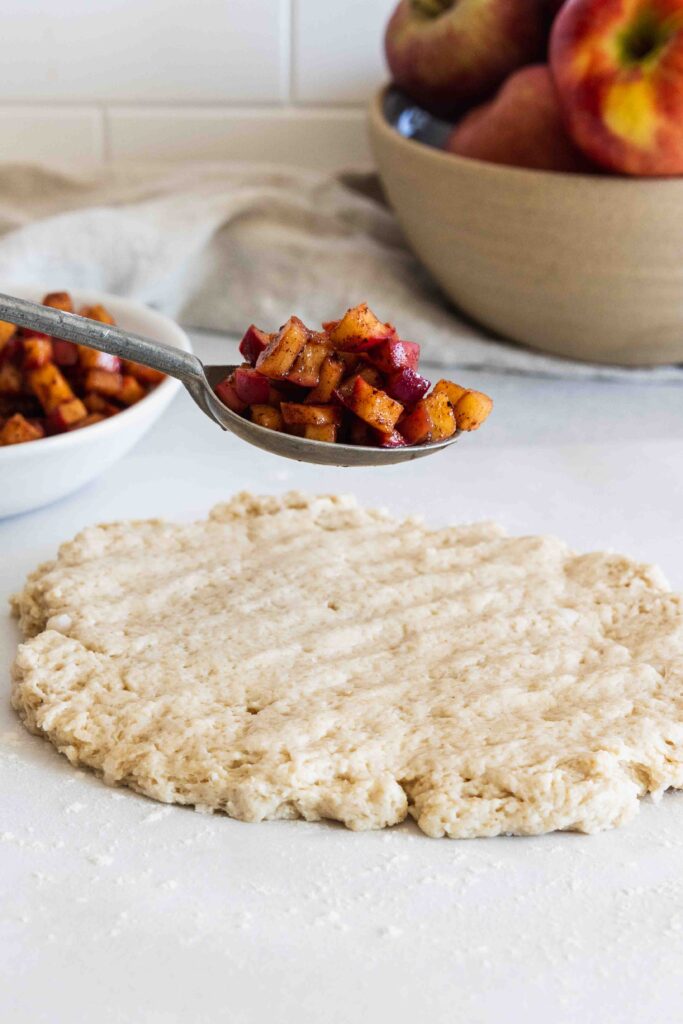 Adding apple filling to the scone dough