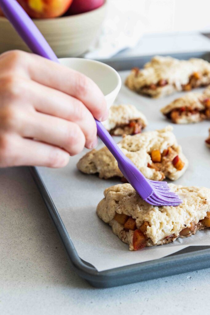 Brushing the scones with coconut milk before baking