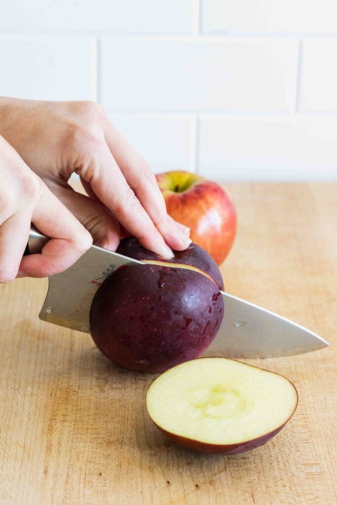 Slicing apples on a wooden cutting board