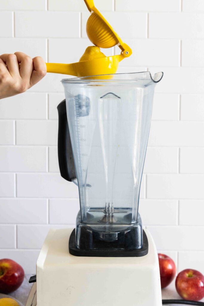 Adding lemon juice to a blender
