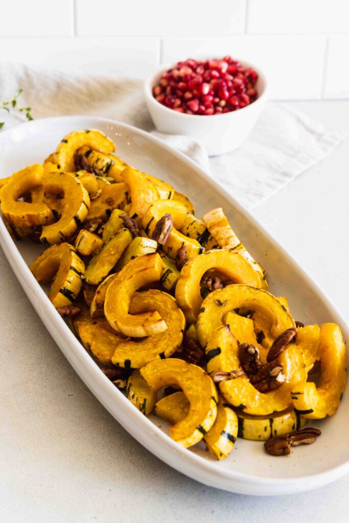 Adding toasted pecans to the roasted delicata squash