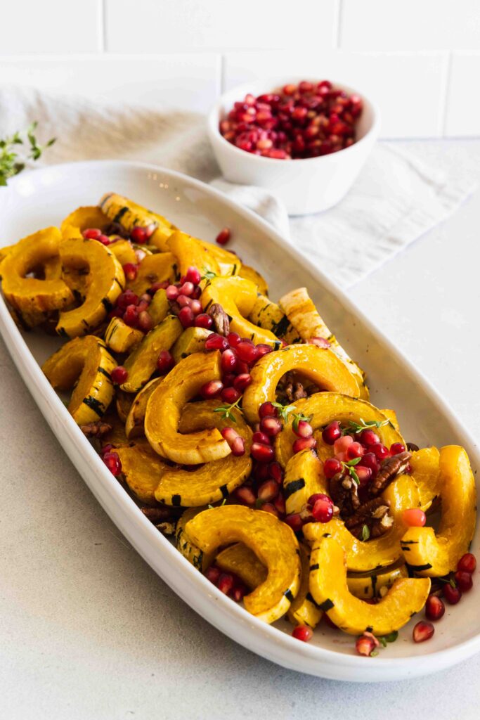 Red pomegranate seeds added to the top of the roasted delicata squash