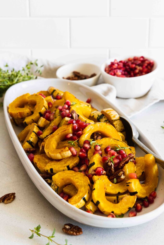 Roasted delicata squash with pomegranate seeds and toasted pecans