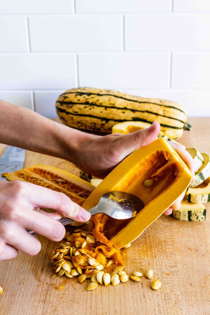 Removing the seeds from the middle of the squash
