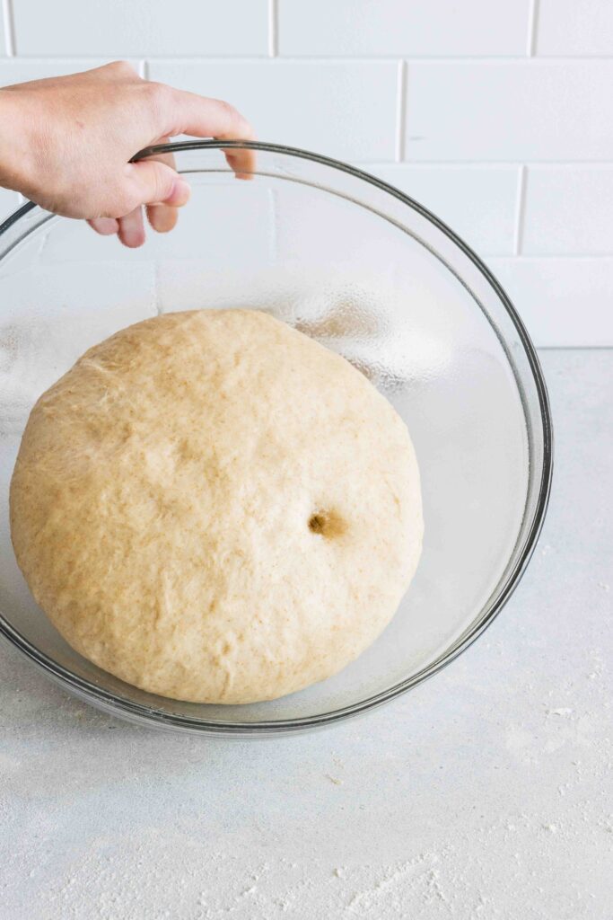 The finger test to see if the dough is done rising.