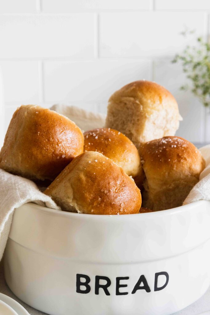 Vegan dinner rolls perfectly golden brown in a bread basket
