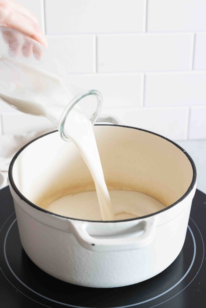Warming almond milk in a pot on the stove