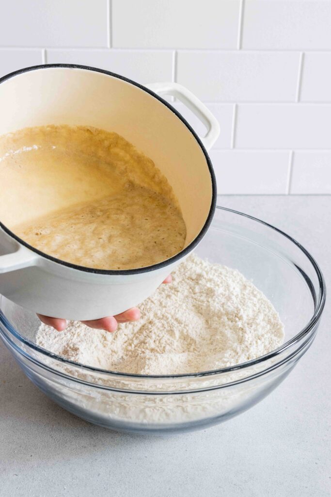 Pouring in the yeast mixture into the flour mixture