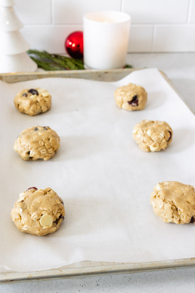 Pressing the cookie dough balls slightly to get the perfect cookie shape