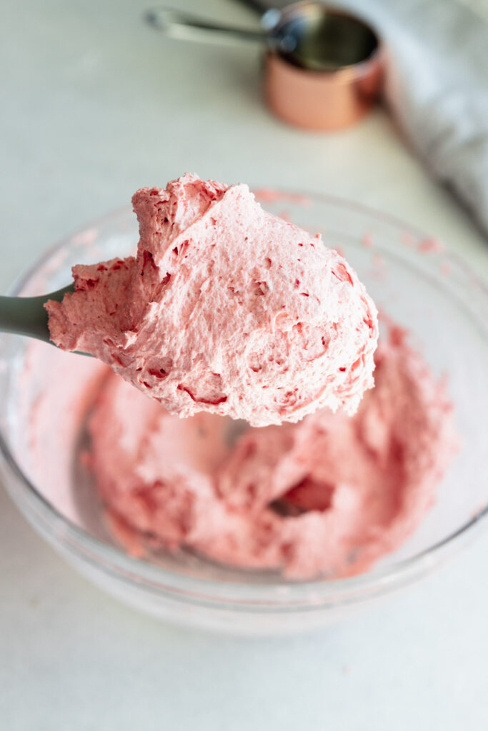 Beautiful strawberry frosting on a spatula