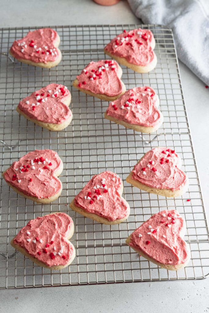 Soft frosted sugar cookies decorated on a cooling rack