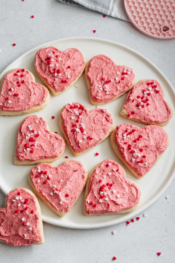Homemade vegan soft frosted sugar cookies served on a white platter