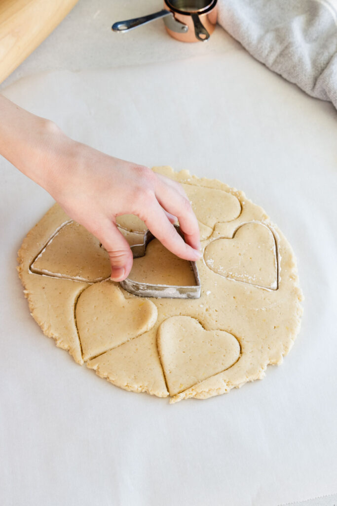 Cutting the cookies out with cookie cutters