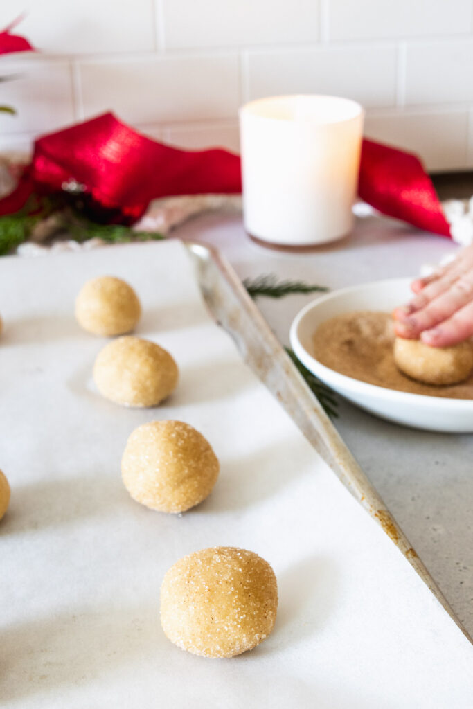 Rolling snickerdoodle cookie dough in cinnamon sugar
