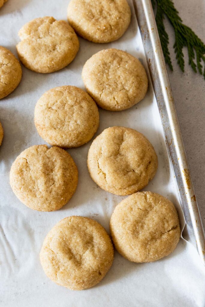 Soft vegan snickerdoodle cookies on a baking sheet